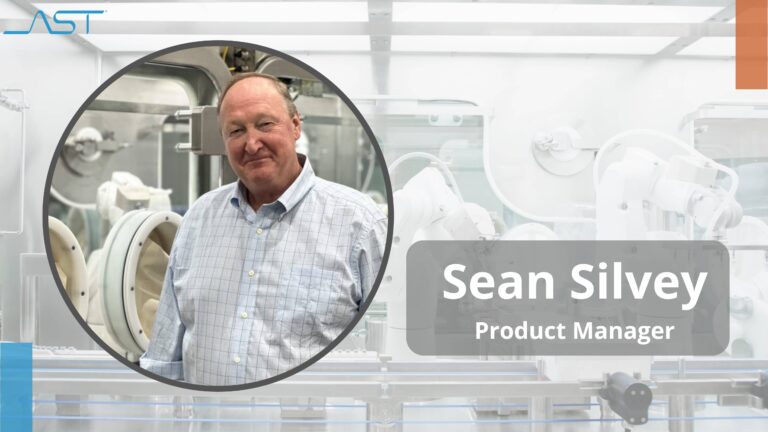 A photo of Sean Silvey, product manager at AST, in front of aseptic processing machinery